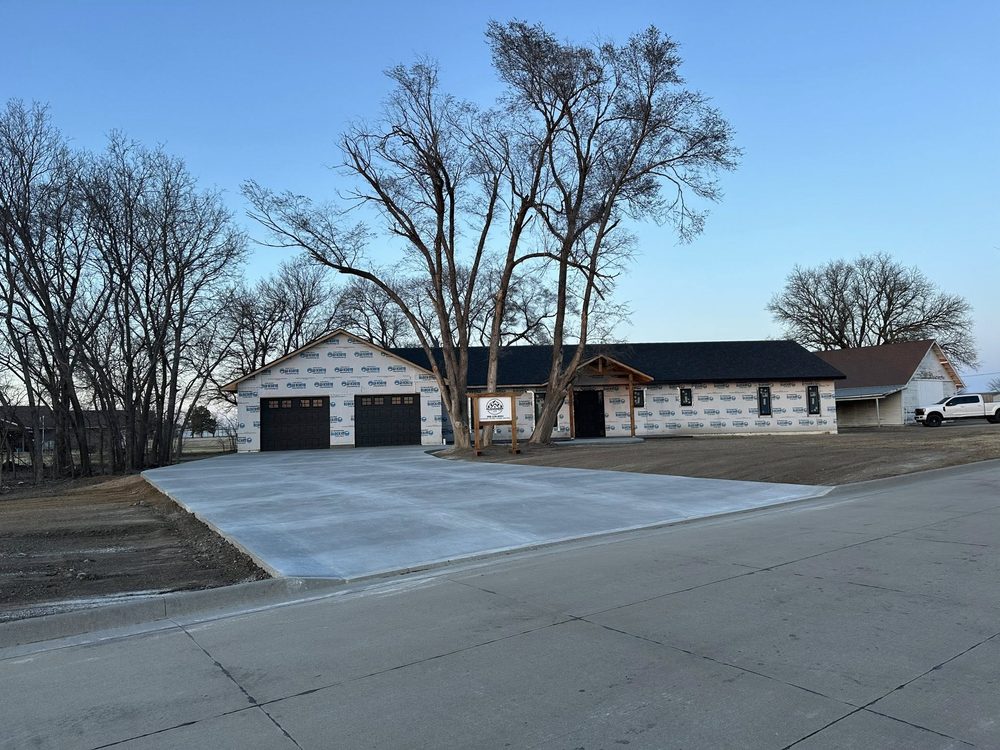 Custom home in winter with snow-tinged ground