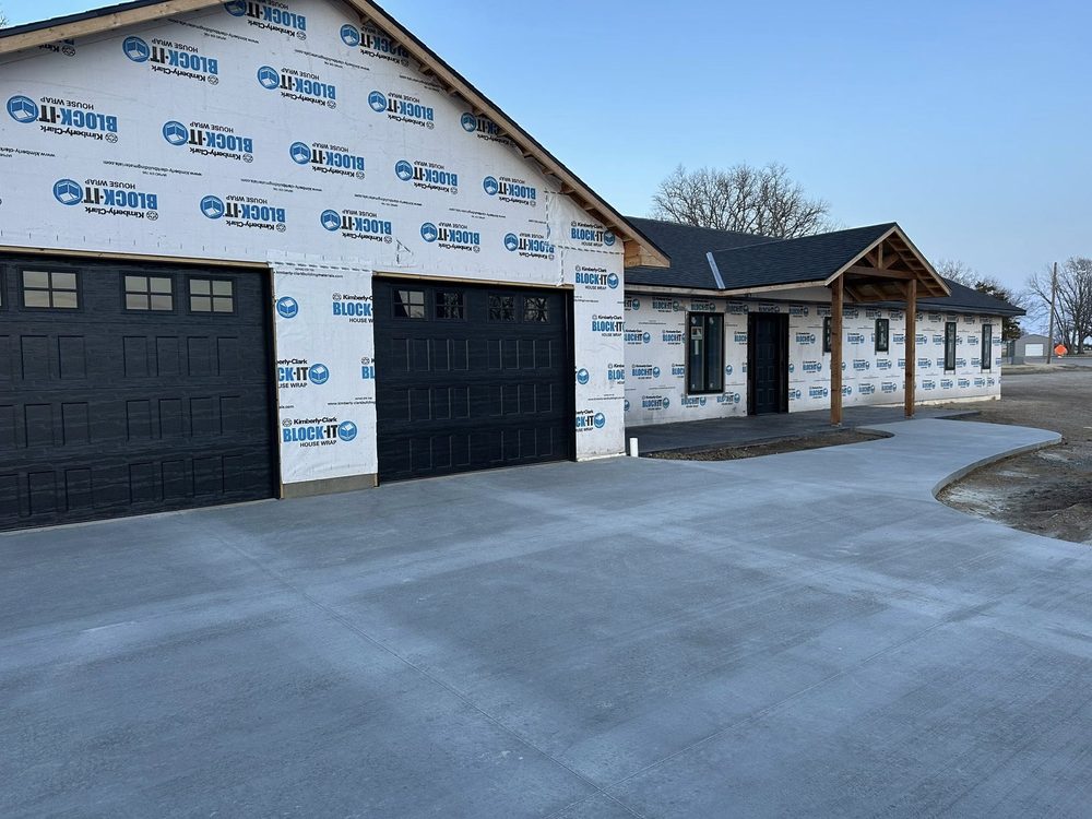 Custom home with timber-frame porch and concrete drive