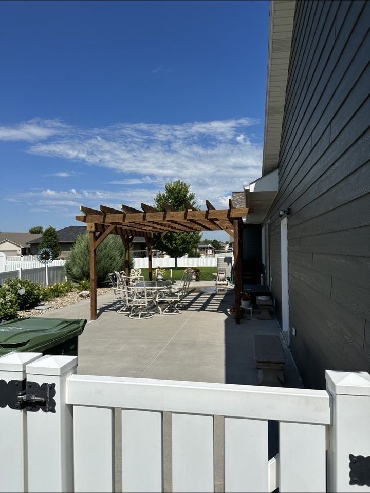Custom pergola over concrete patio next to a Kansas home built by BlackRidge Contracting